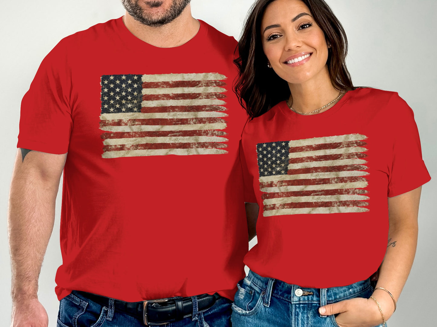 Couple wearing matching red t-shirts with distressed American flag graphic.
