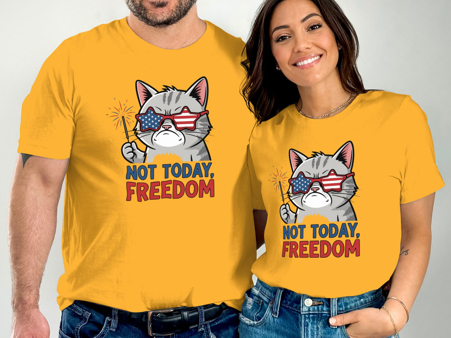 Couple wearing matching t-shirts with a cartoon cat wearing sunglasses and holding sparklers.