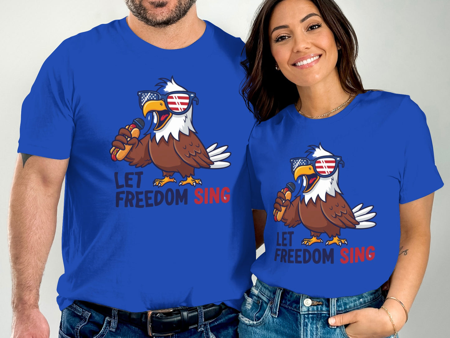 Two people in matching blue t-shirts with an eagle singing into a microphone.