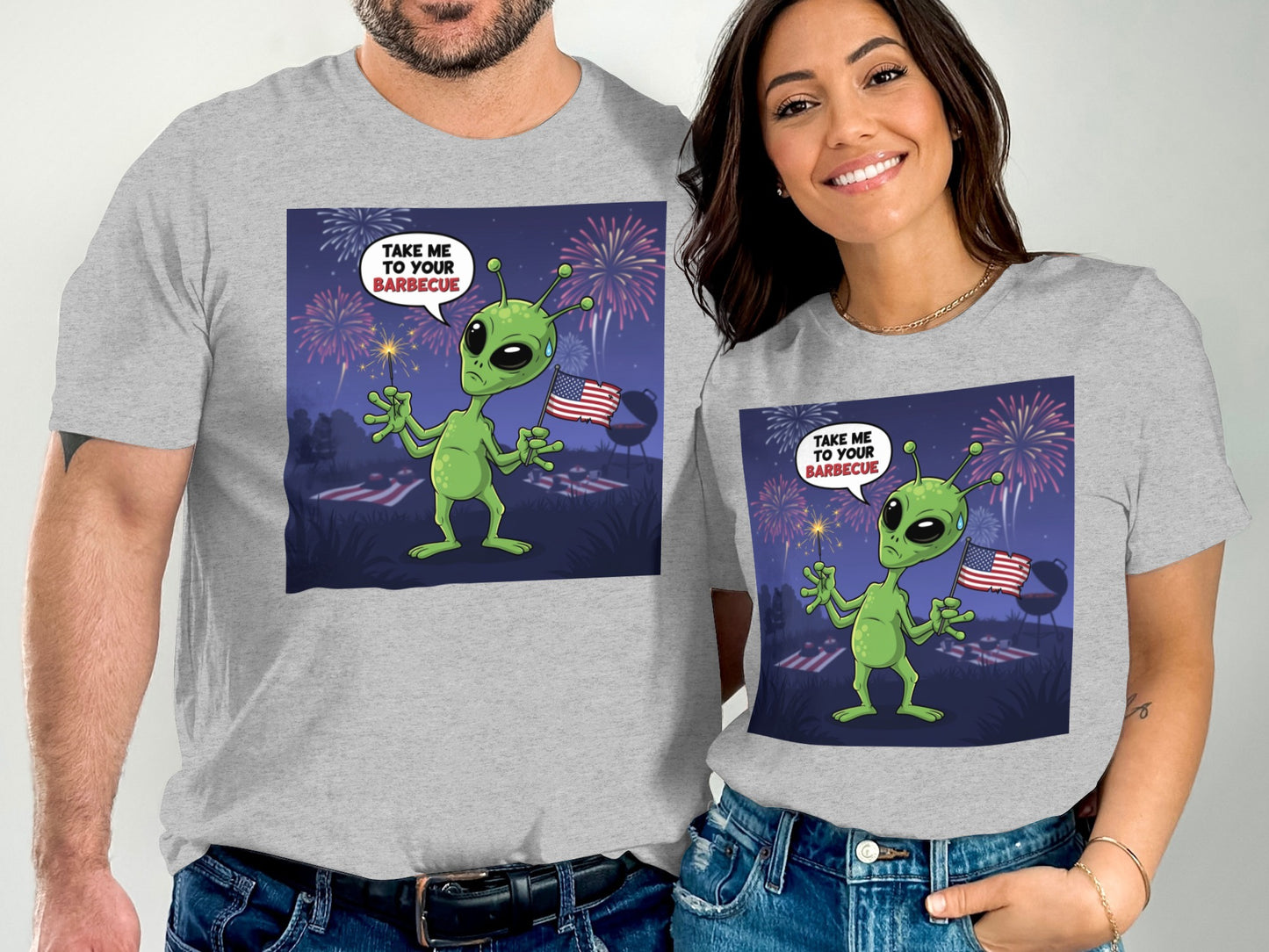 Couple wearing t-shirts with alien, fireworks, and "Take me to your barbecue."