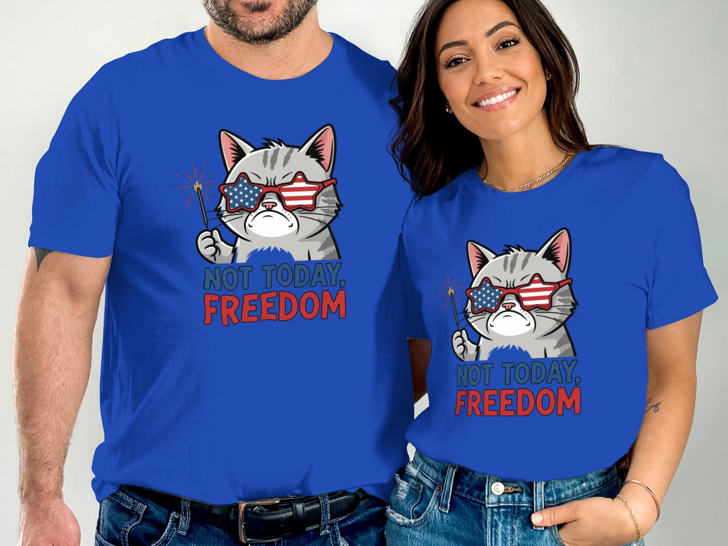 Two people wear matching blue t-shirts with a patriotic cat graphic.