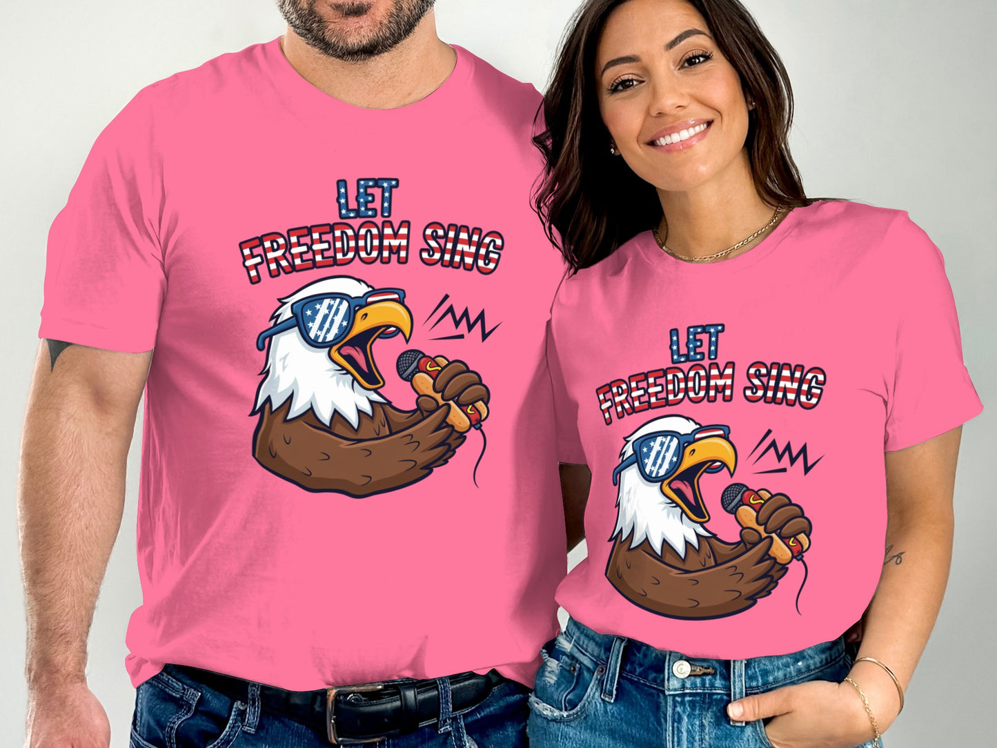 Couple in pink t-shirts with "Let Freedom Sing" and eagle graphic.
