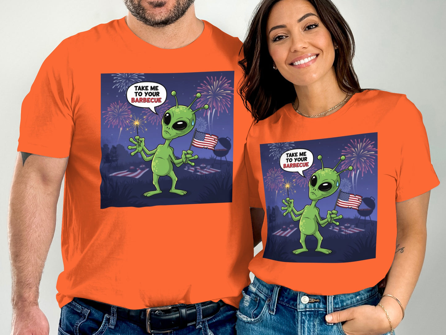 Orange t-shirts with cartoon alien holding sparkler and text "Take Me To Your Barbecue."