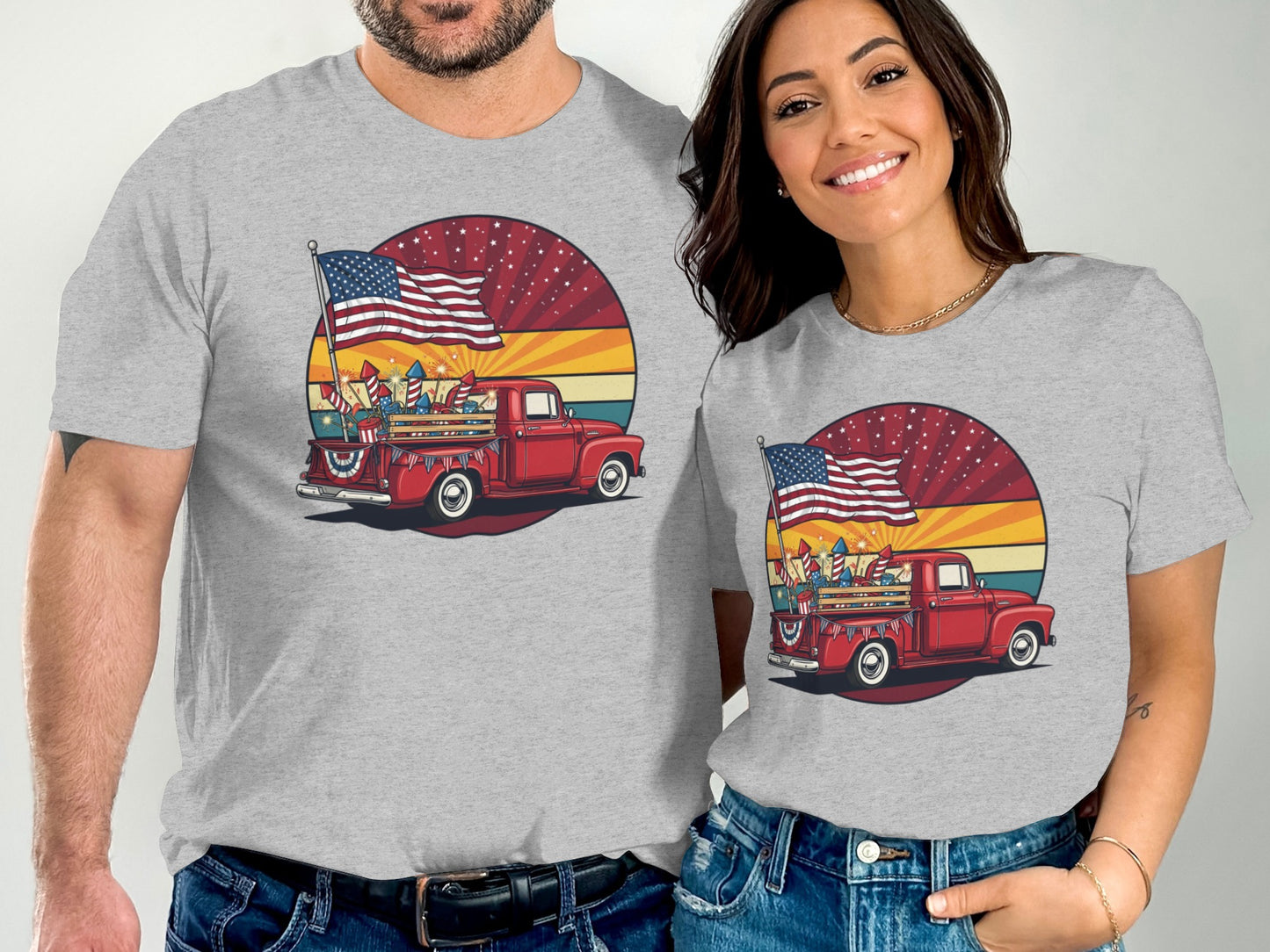 Two people wearing t-shirts with a red vintage truck and American flags.