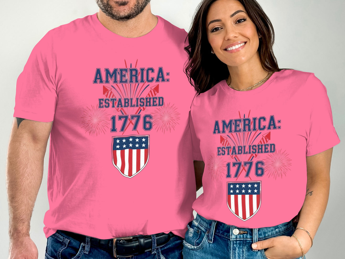 Pink t-shirts with "America: Established 1776" and a shield emblem.
