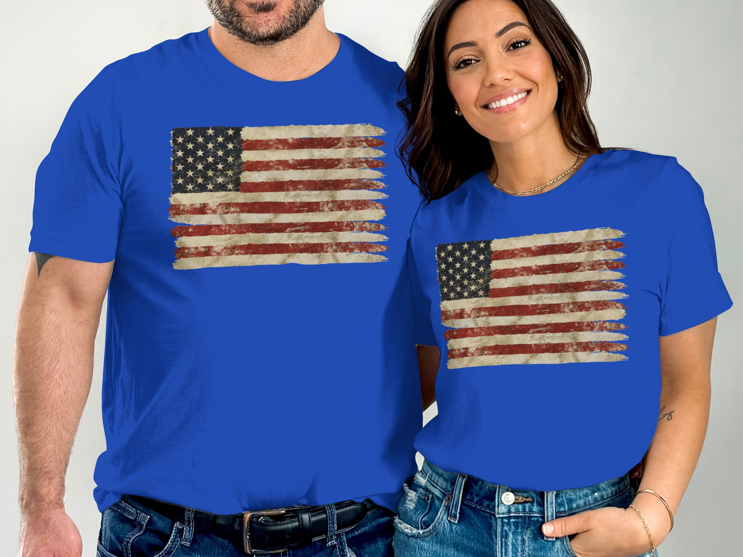 Two people wearing blue t-shirts with distressed American flag graphic.