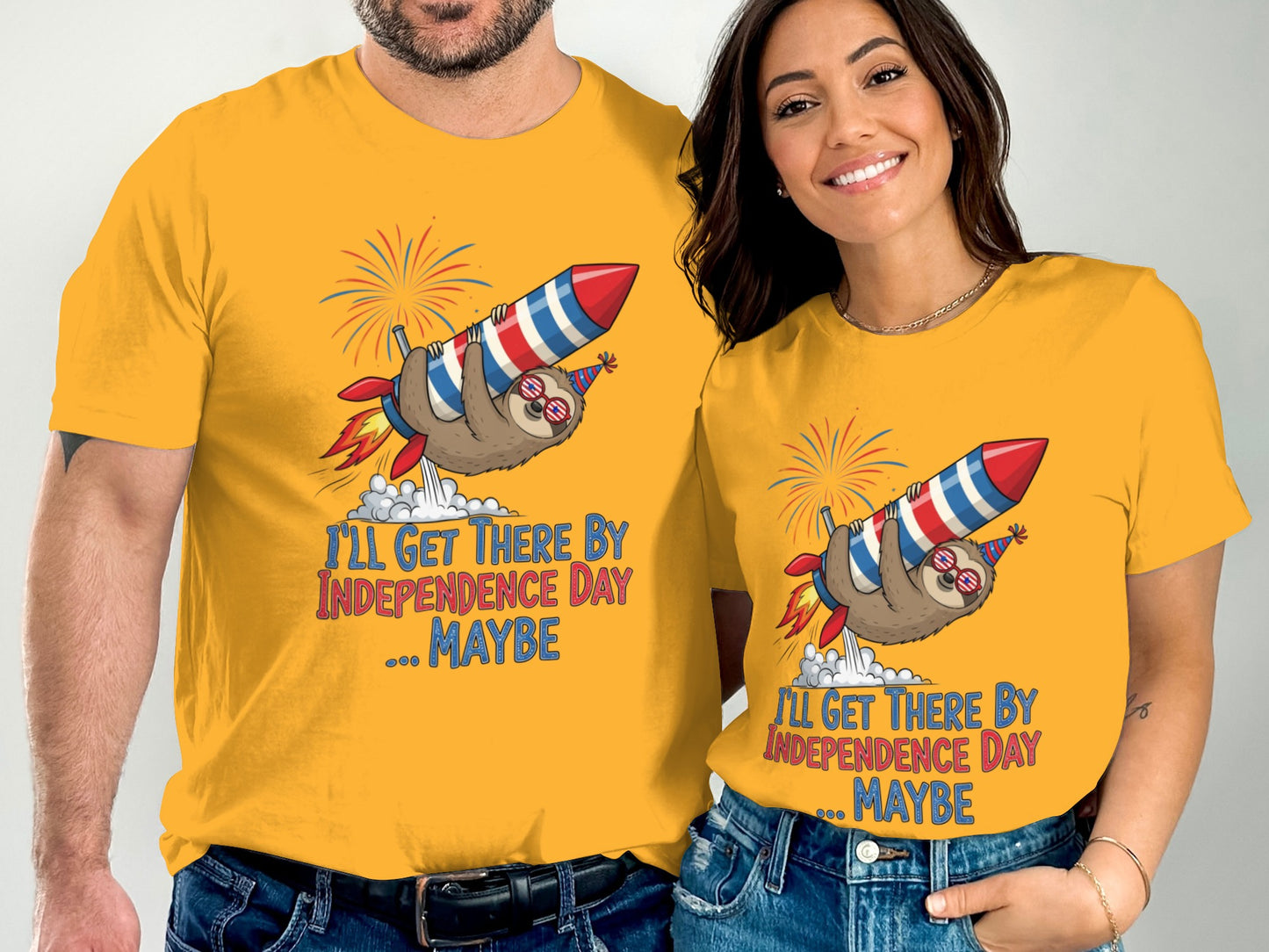 Couple wearing yellow t-shirts with sloth on rocket graphic and "I'll Get There By Independence Day...Maybe" text.