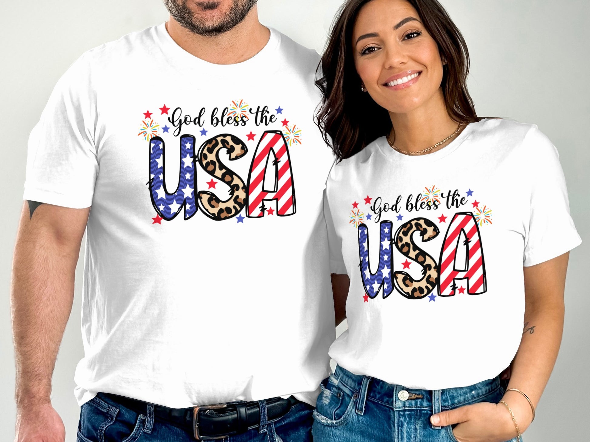 Two people wear white t-shirts with "God bless the USA" and American flag design.
