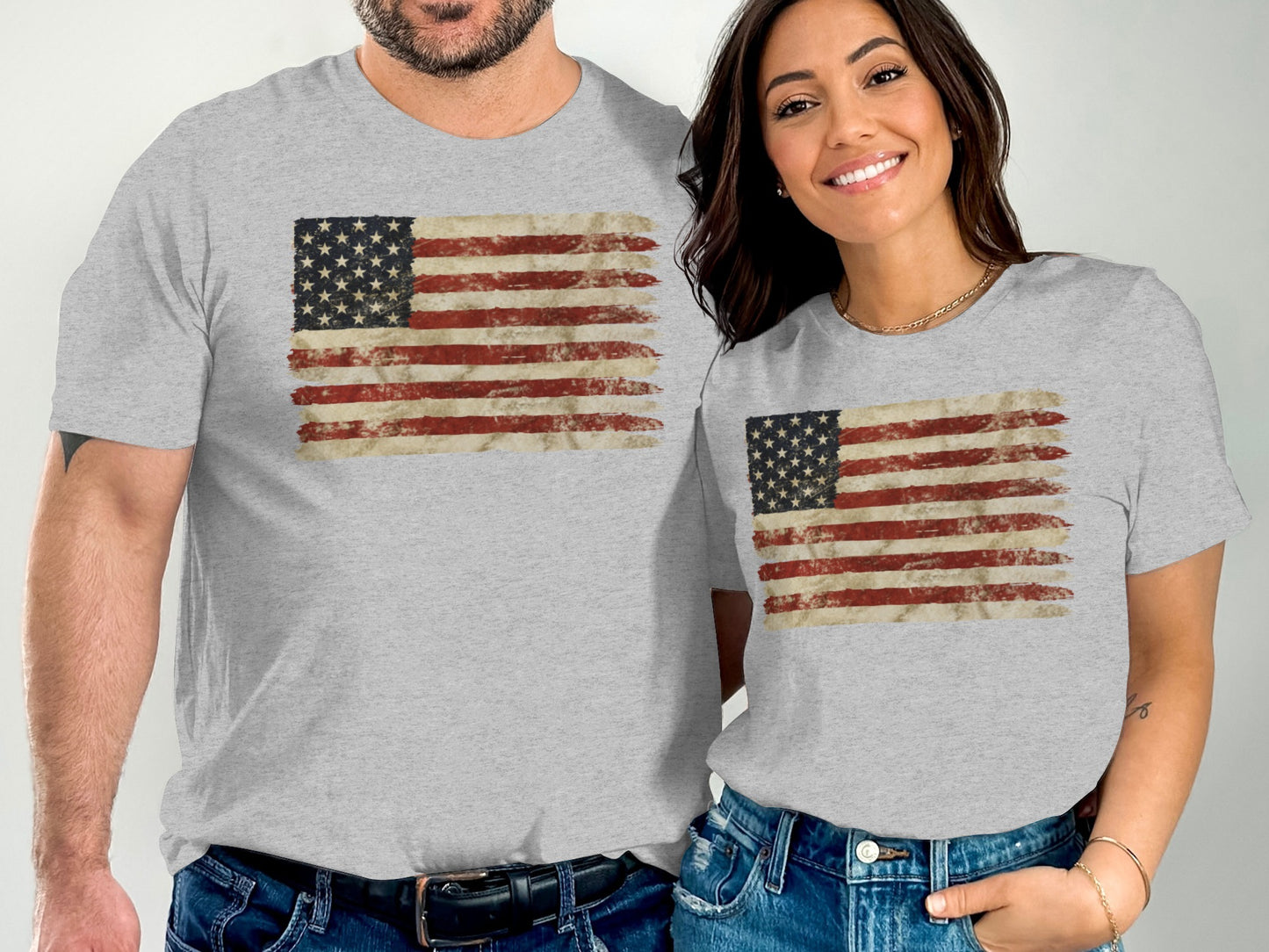 Two people wearing matching t-shirts with a distressed American flag design.