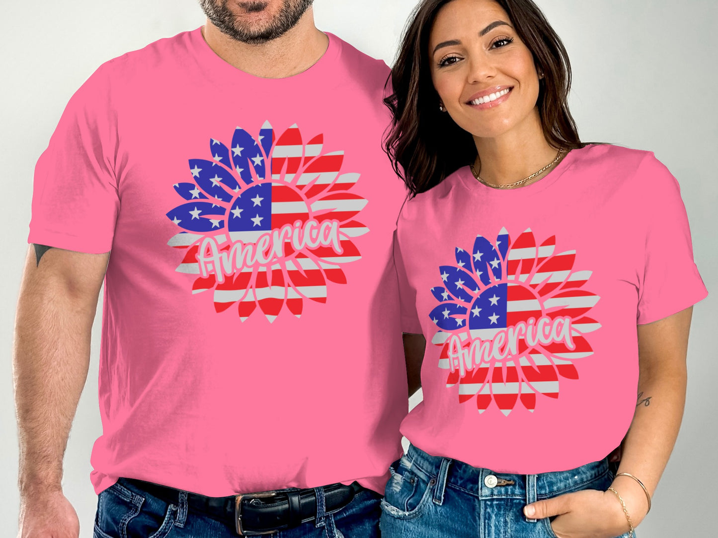 Two people wearing pink t-shirts with sunflower designs featuring the American flag and "America."