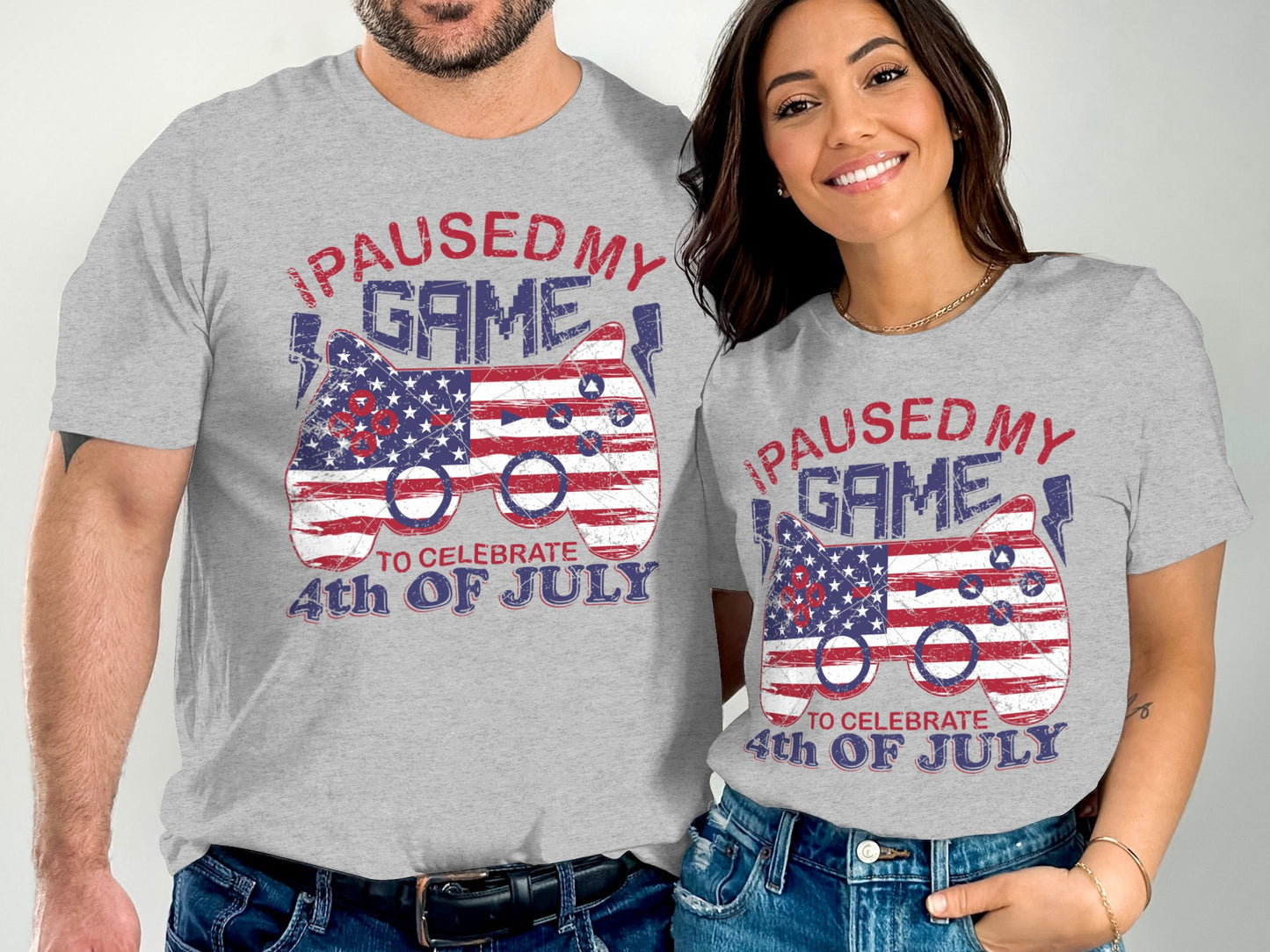 Men's and women's t-shirts with "I paused my game to celebrate 4th of July" text and US flag controller.