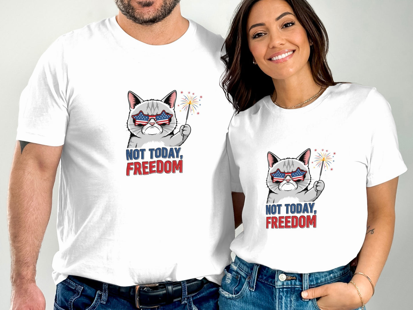 Two people wearing matching white t-shirts with a patriotic cat graphic.