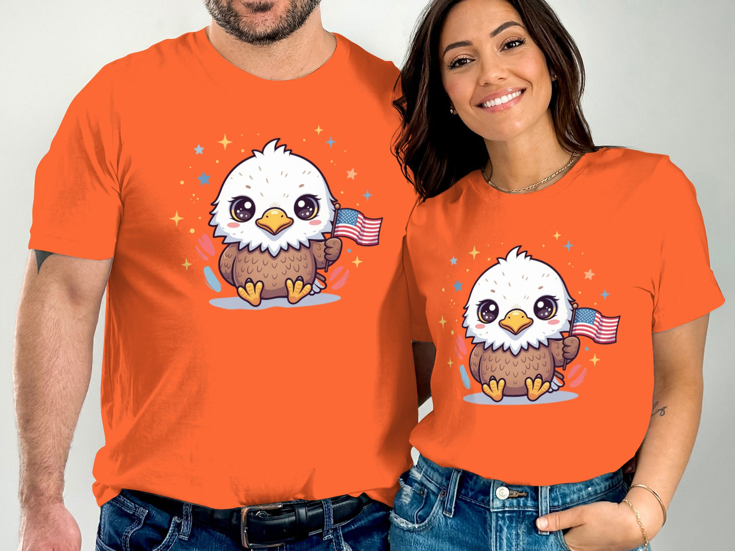 Two people in orange t-shirts featuring a cartoon eagle holding an American flag.