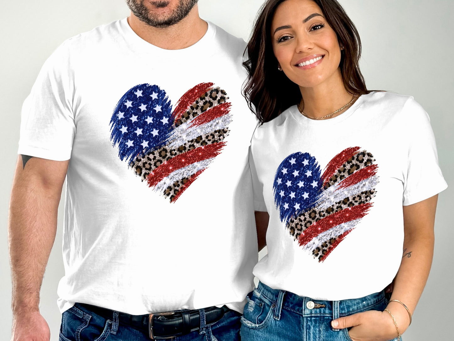 Couple wearing matching white t-shirts with distressed American flag heart design.