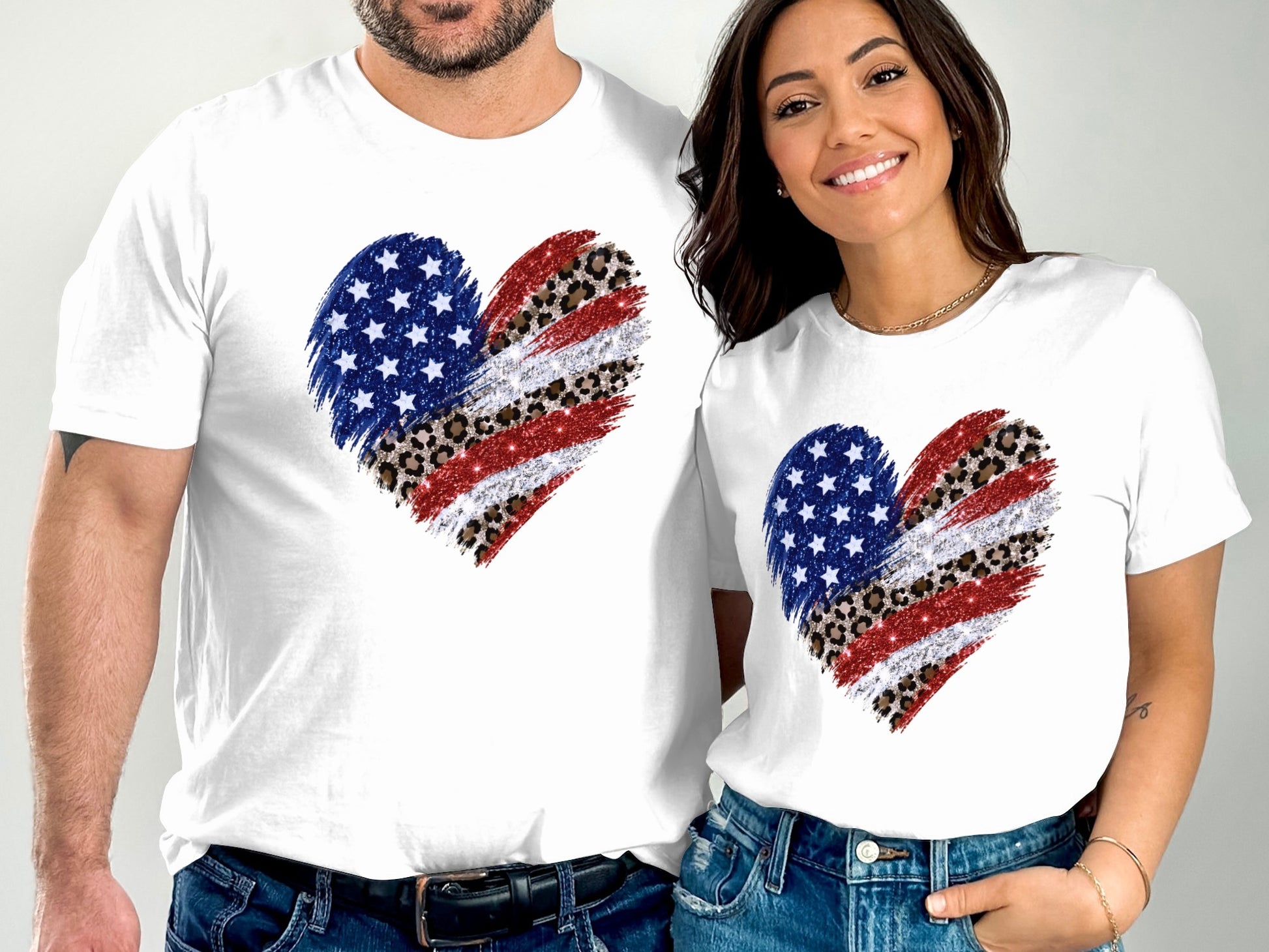 Couple wearing matching white t-shirts with distressed American flag heart design.