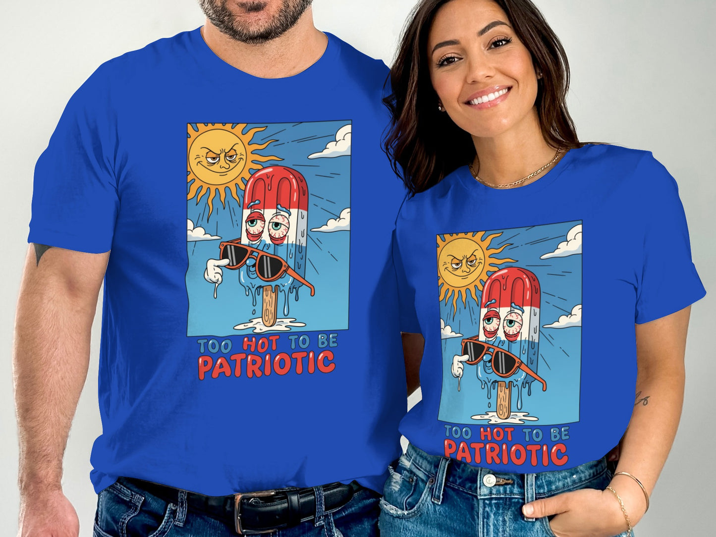 Man and woman wearing shirts with patriotic popsicle cartoon, "Too Hot To Be Patriotic".