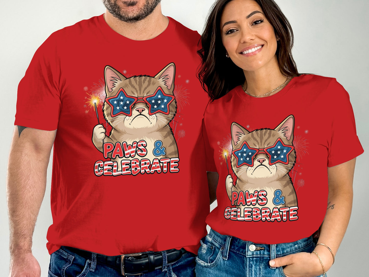 Couple wearing matching red shirts with cat graphic, "Paws & Celebrate" text.