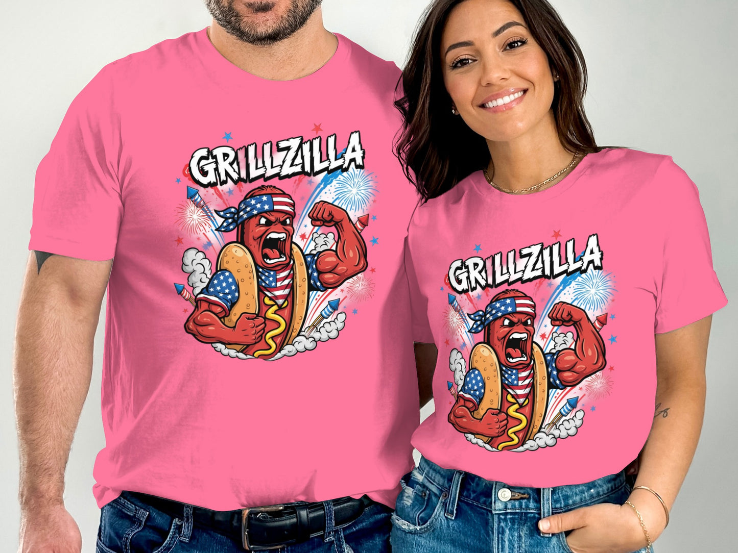 Two people wear pink t-shirts with "GRILLZILLA" and a flexing hot dog graphic.