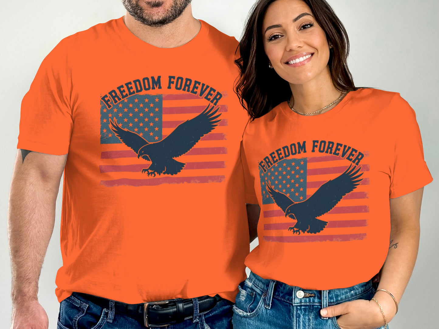 Two people wearing orange t-shirts with an eagle and American flag design.