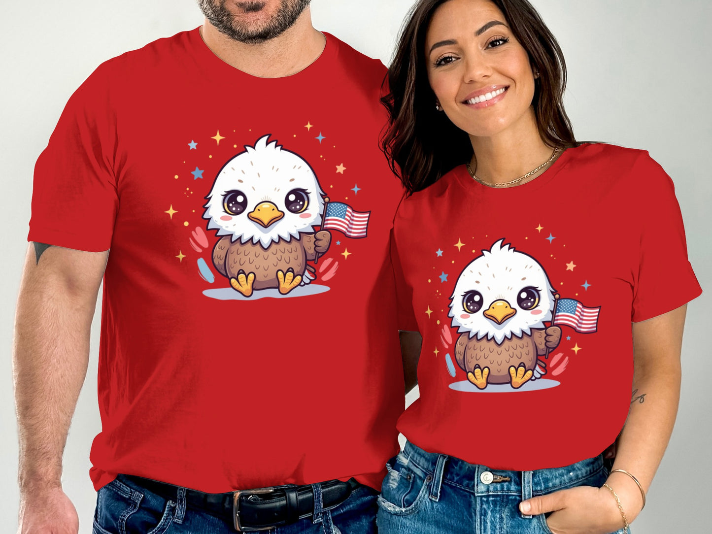 Two people wear matching red t-shirts with a cartoon bald eagle holding a US flag.