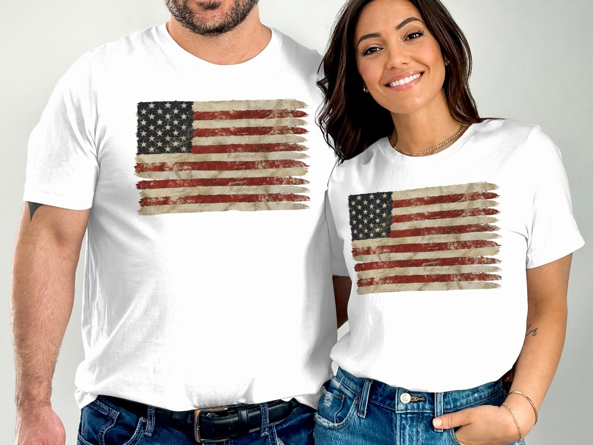 Two people wear white t-shirts with a distressed American flag graphic.