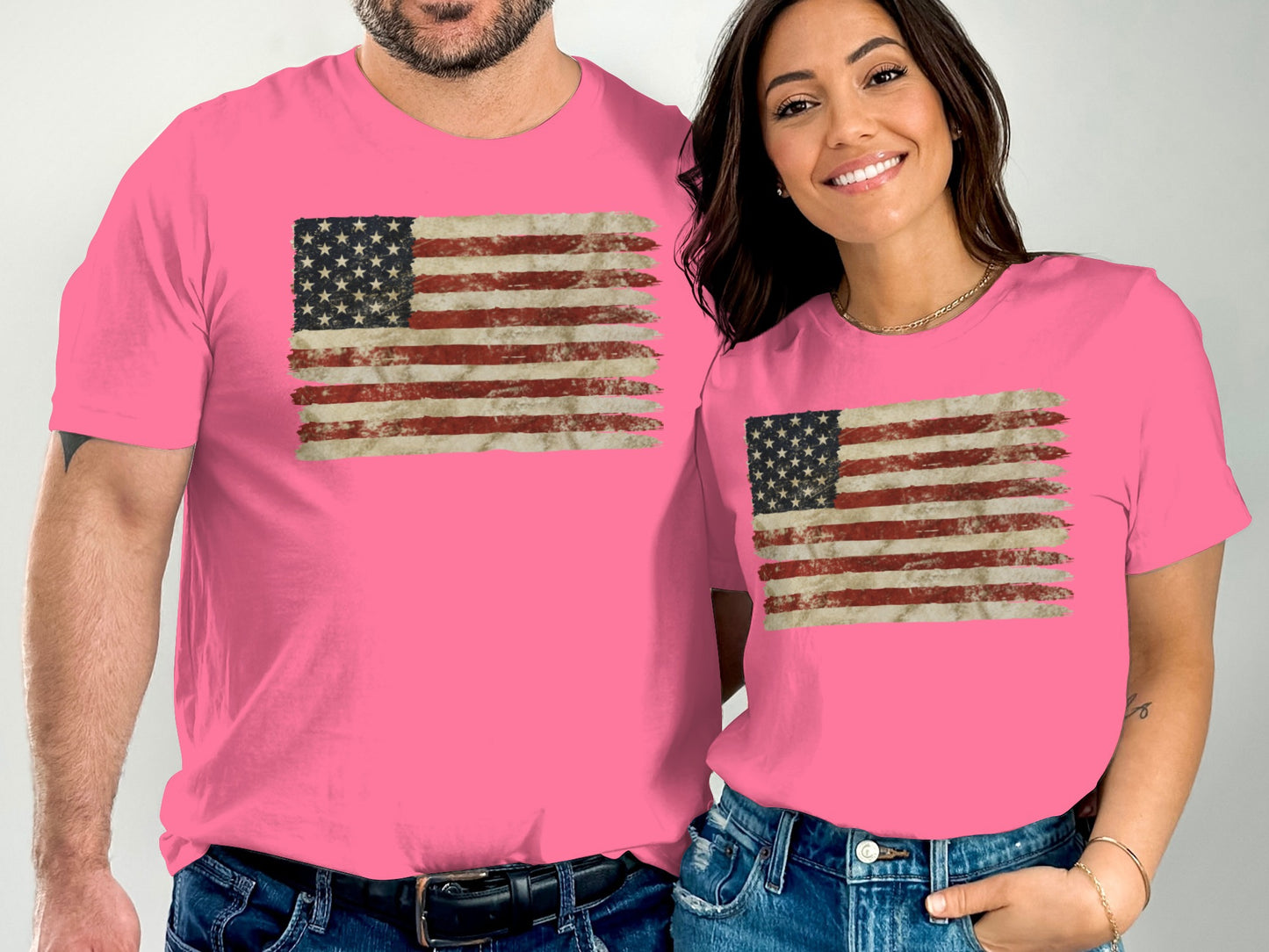 Two people wearing pink t-shirts with distressed American flag graphic.