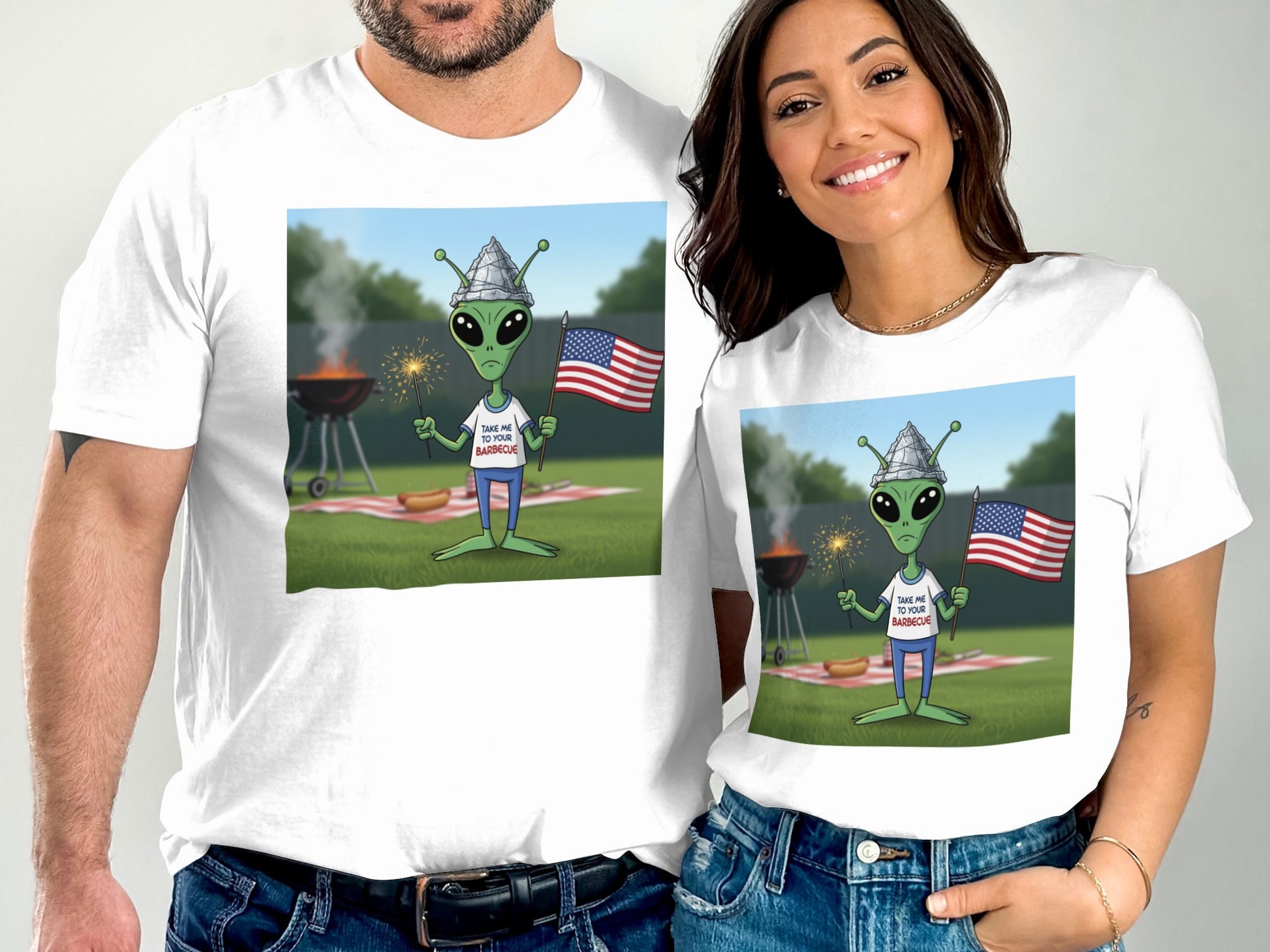 Couple wearing matching t-shirts with cartoon alien at a barbecue.