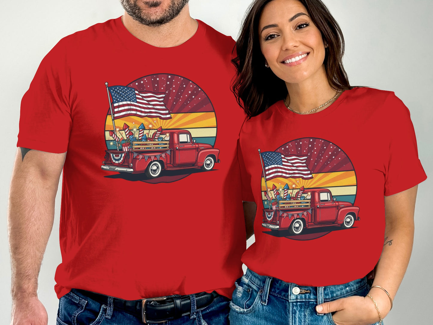 Red t-shirts featuring a vintage red truck with an American flag and fireworks.