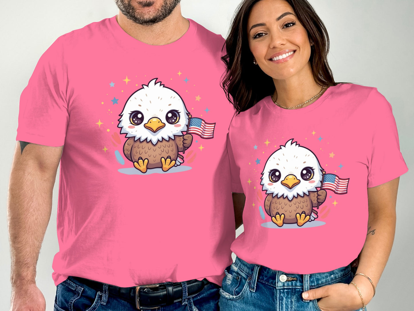 Two people wear matching pink t-shirts with cartoon eagles holding American flags.