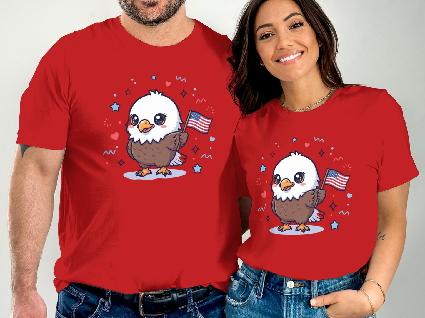 Couple wearing matching red t-shirts with cartoon bald eagle holding US flags.