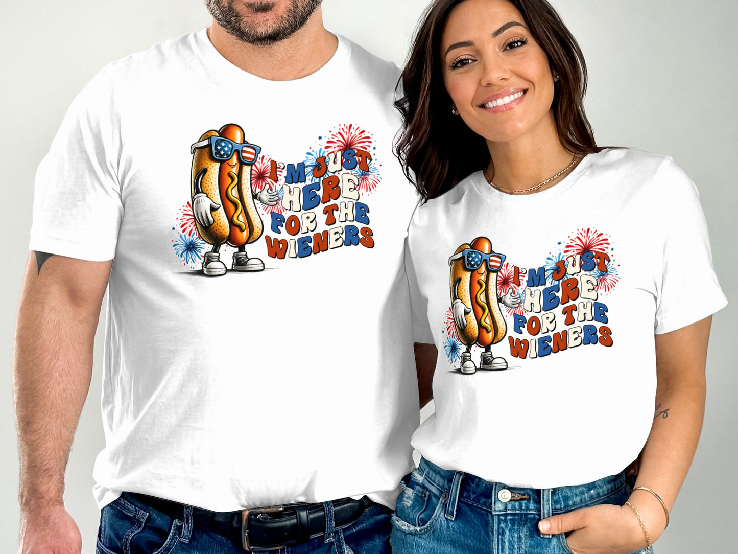 White t-shirts with hot dog graphic and text "I'm Just Here For The Wieners".
