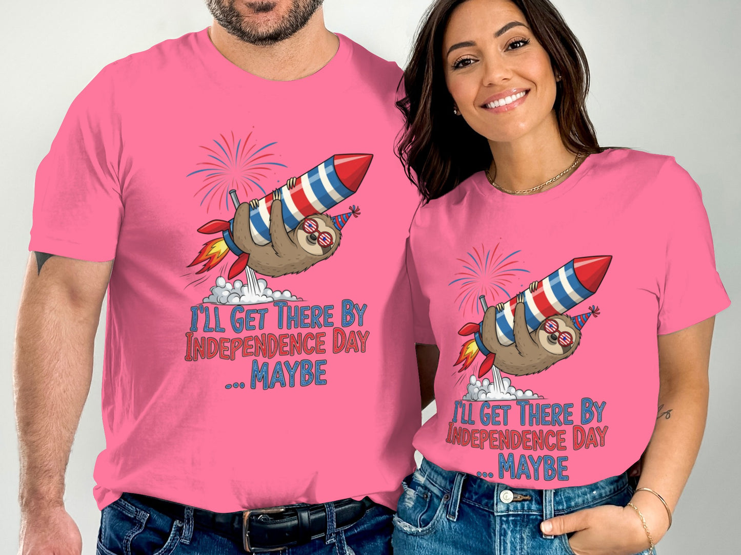 Pink t-shirts with sloth riding a rocket and text "I'll get there by Independence Day... maybe."