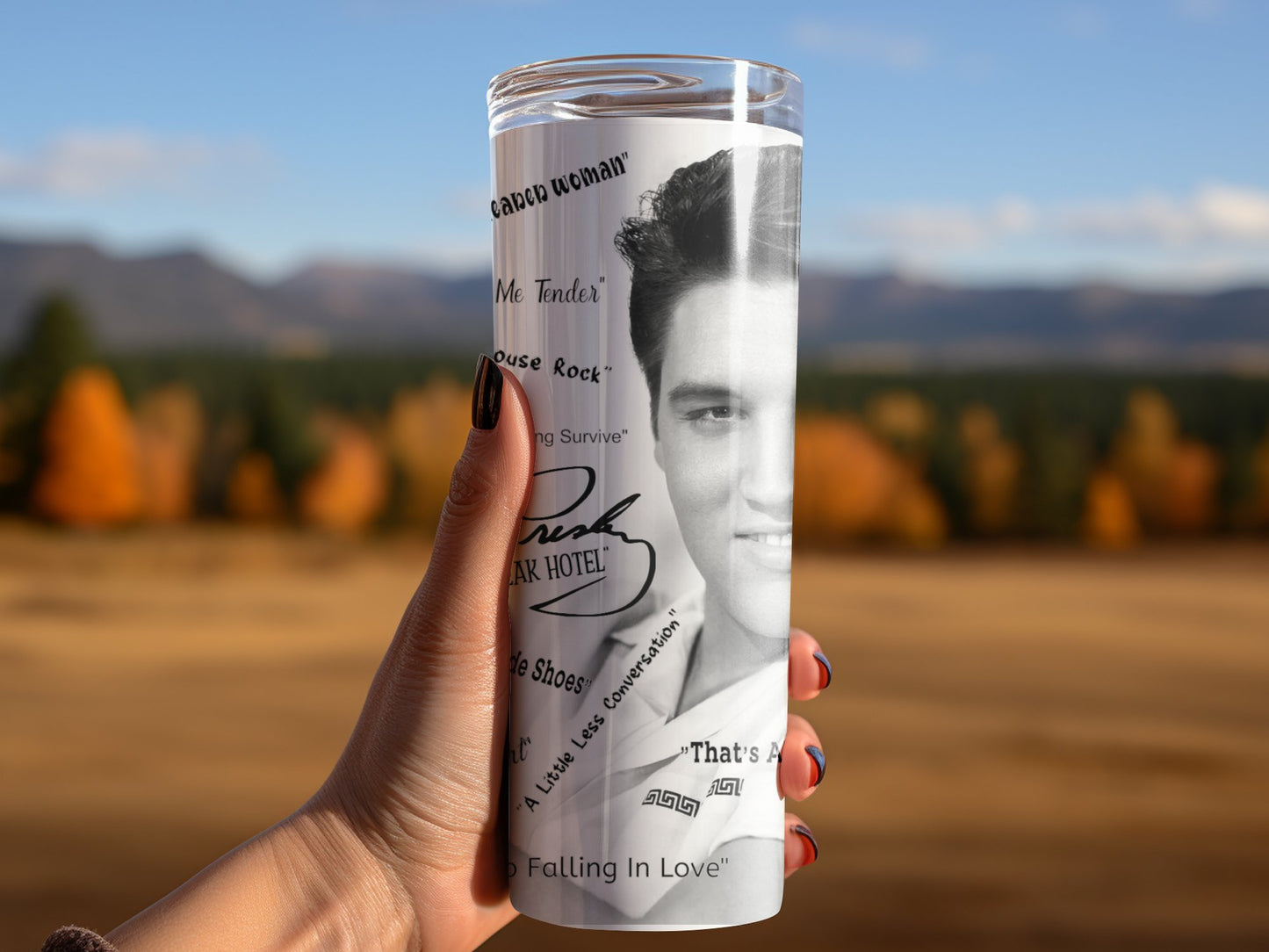 Hand holding an Elvis tumbler gift featuring a black and white photo of Elvis Presley and song titles