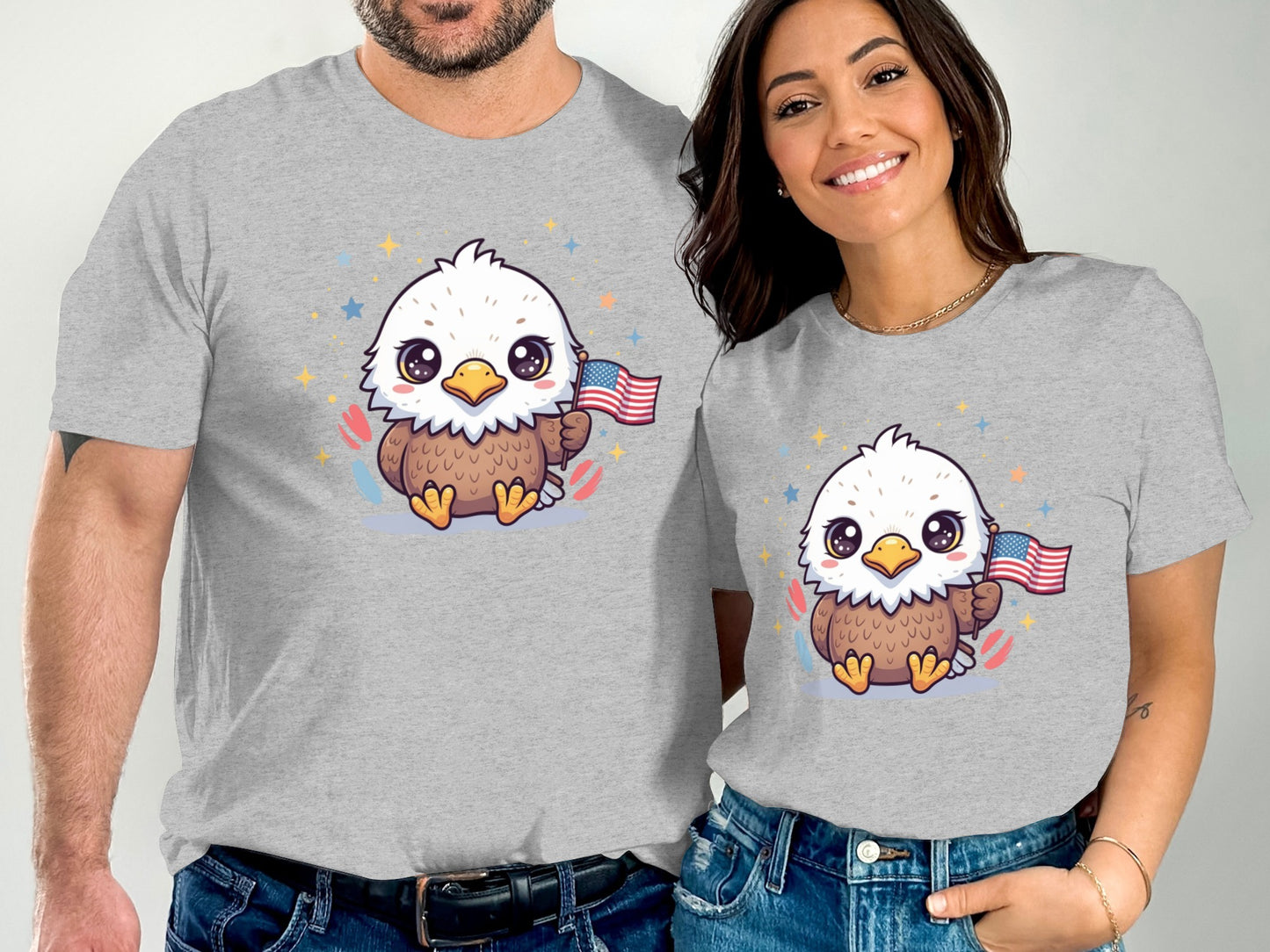 Two people wearing matching grey t-shirts with a cartoon eagle holding a US flag.