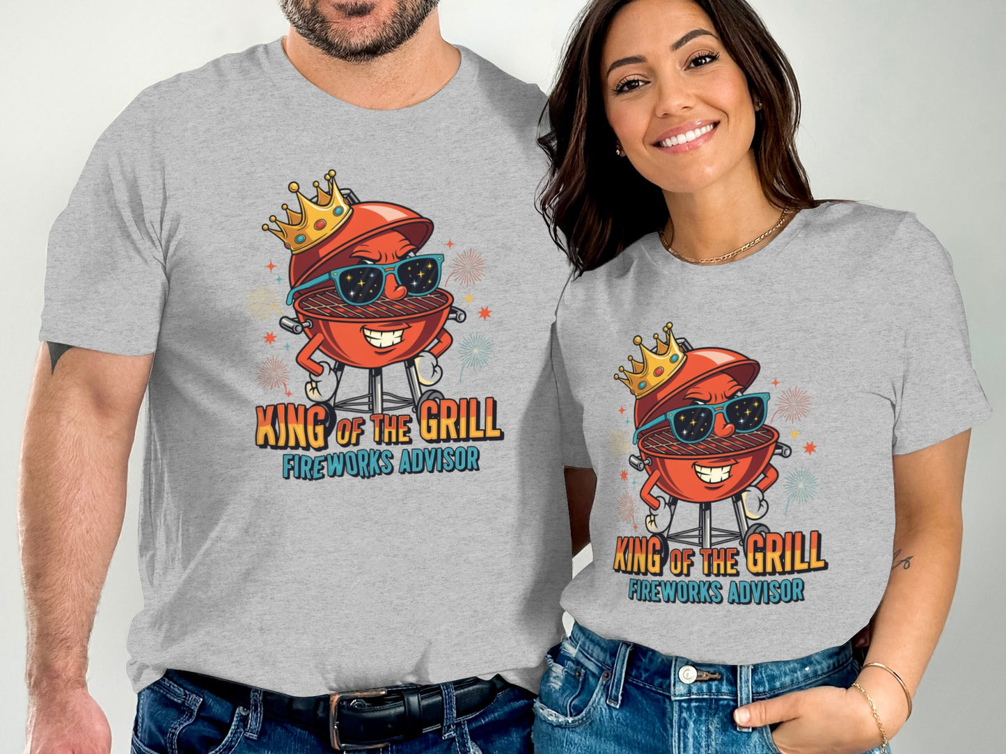 Couple wearing grey t-shirts with cartoon grill saying "King of the Grill Fireworks Advisor".