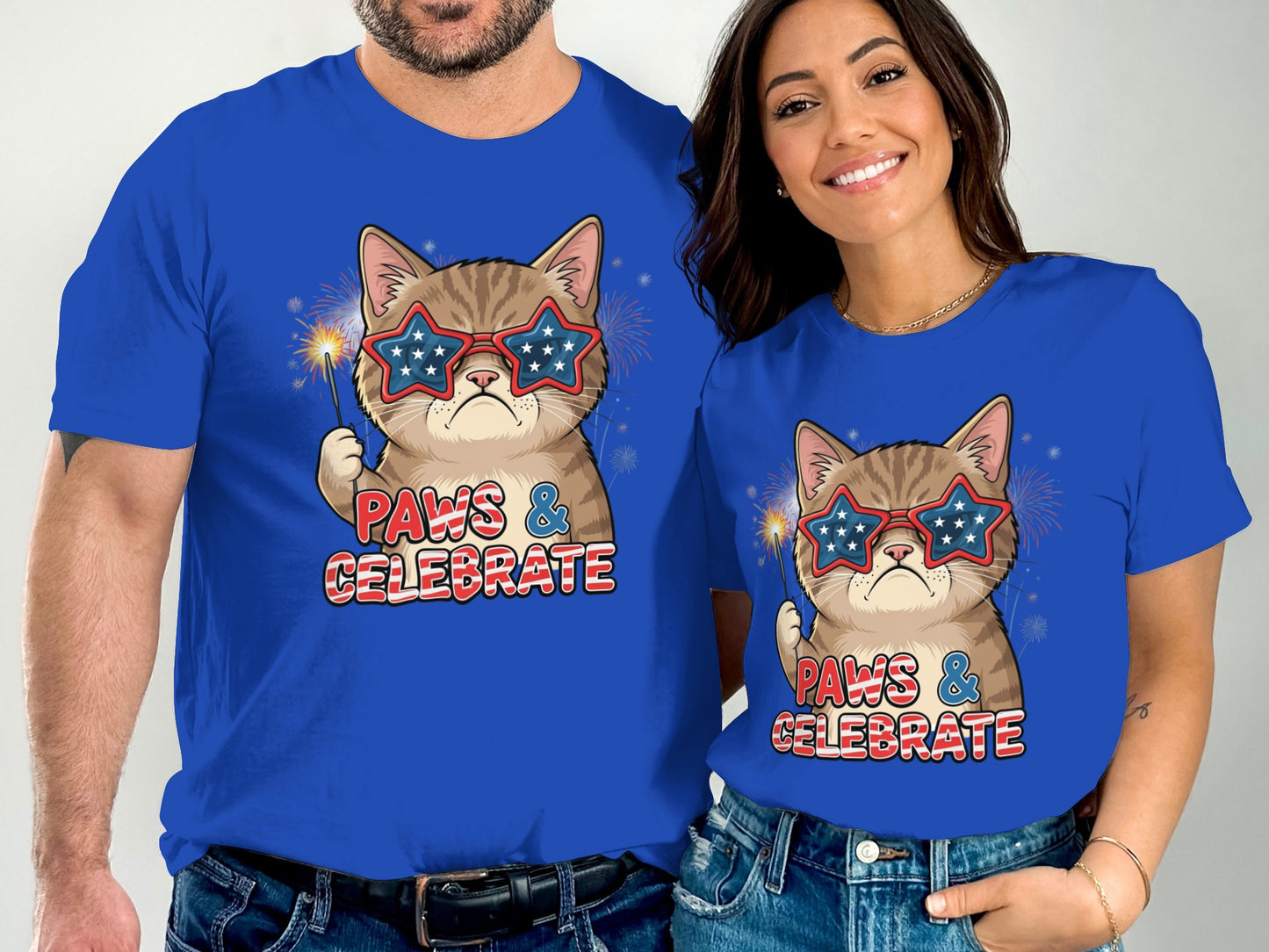Couple wearing matching "Paws & Celebrate" t-shirts with patriotic cat graphic.