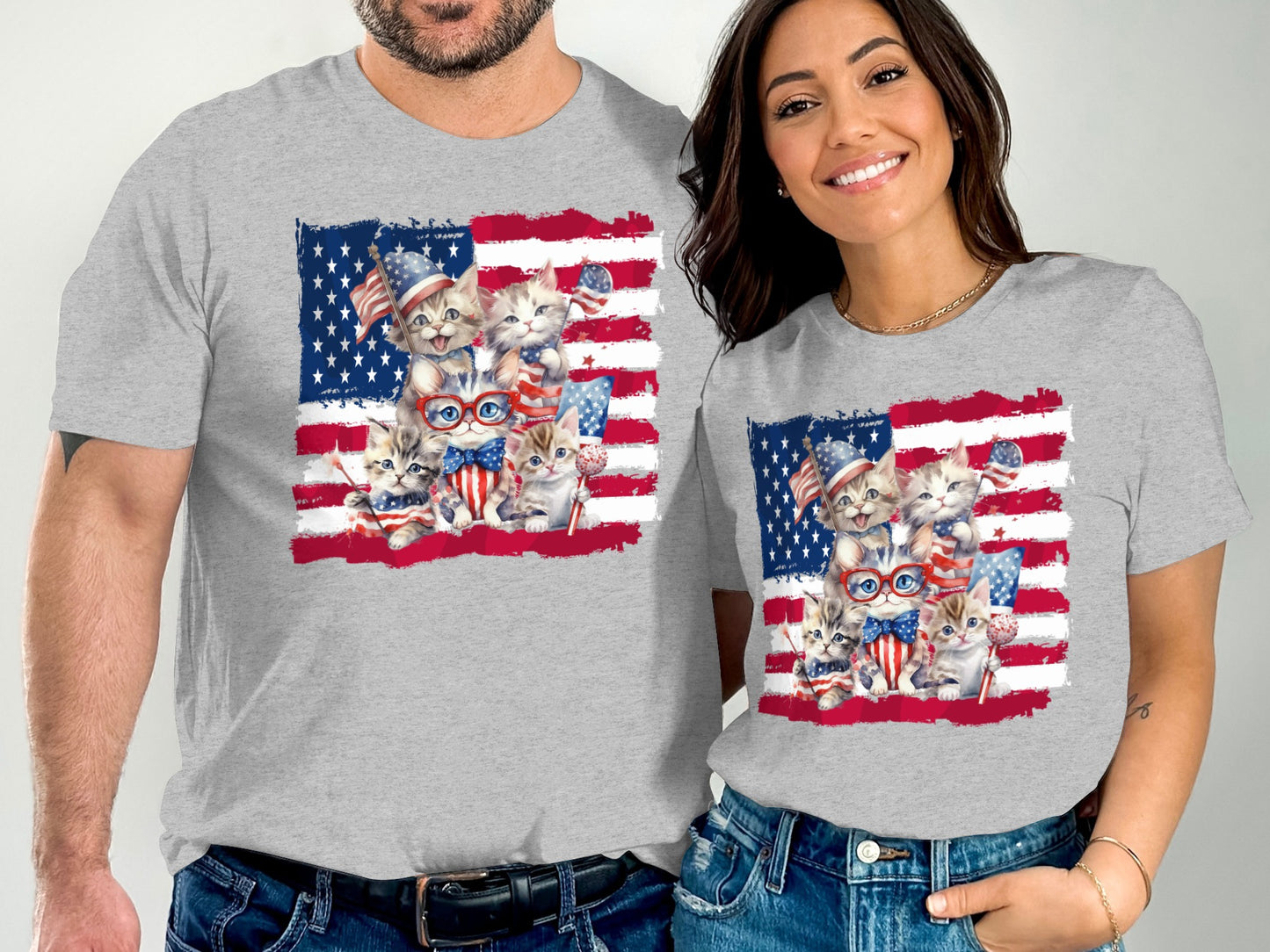 Two people wearing grey t-shirts with patriotic kittens and American flags.