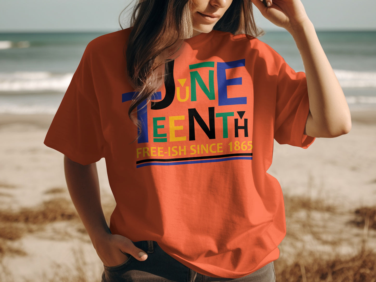 Woman wearing a colorful Juneteenth T-Shirt with text Free-ish Since 1865 on the beach