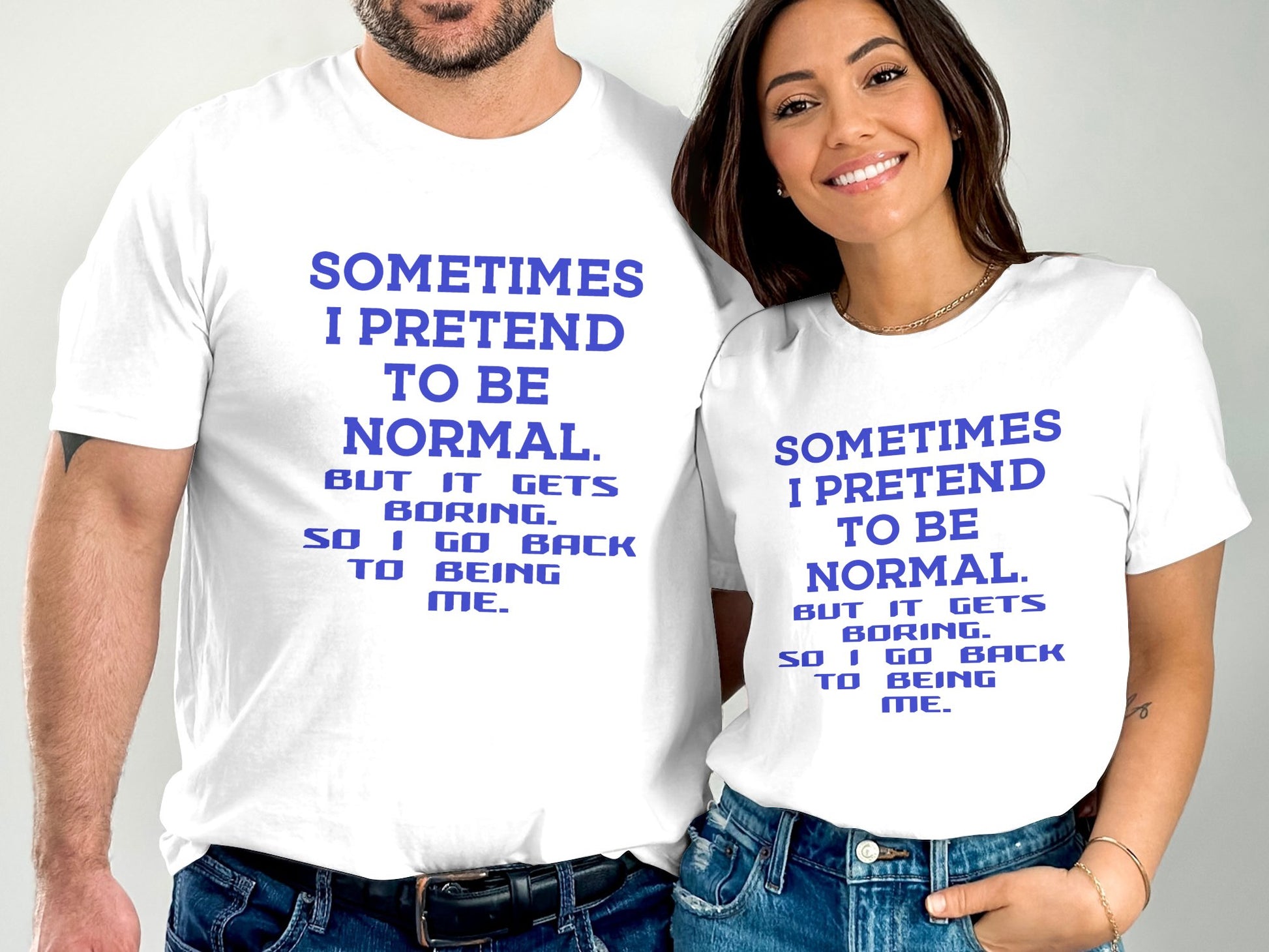 White T-Shirts with Sometimes I pretend to be Normal printed in blue text worn by smiling man and woman